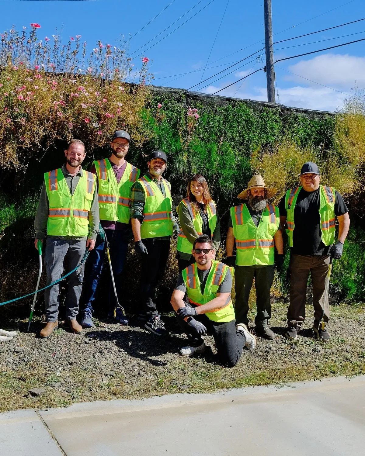 The Mission Always crew on a cleared roadside site in hi-vis vests
